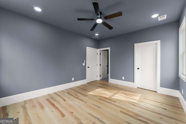 unfurnished bedroom with light wood-type flooring, visible vents, and baseboards