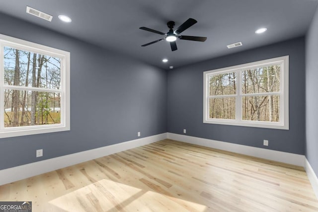 spare room with ceiling fan, recessed lighting, visible vents, baseboards, and light wood-style floors