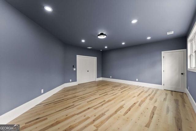 unfurnished room with light wood-type flooring, baseboards, and recessed lighting