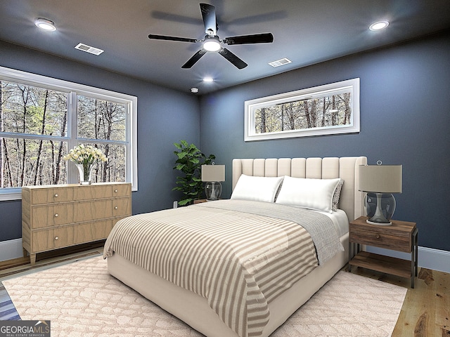 bedroom featuring baseboards, recessed lighting, visible vents, and light wood-style floors