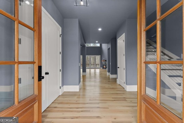 hall with light wood finished floors, recessed lighting, baseboards, and french doors