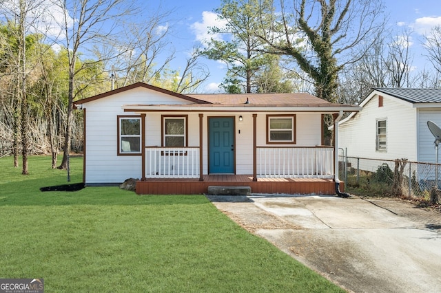 ranch-style house featuring a porch and a front yard