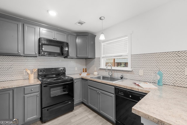 kitchen with gray cabinets and black appliances