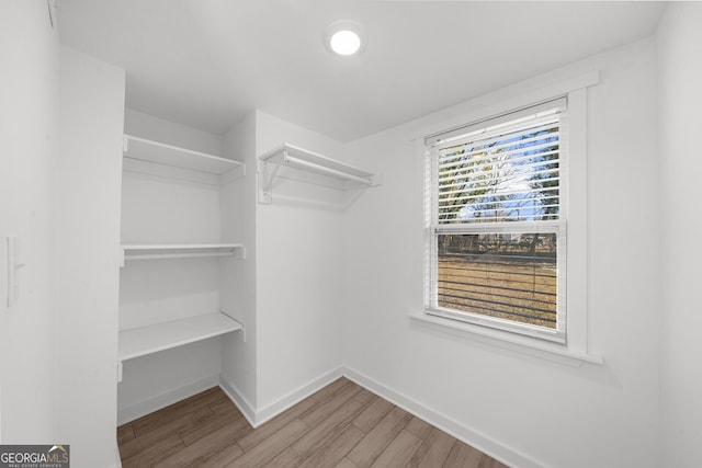 walk in closet with wood-type flooring