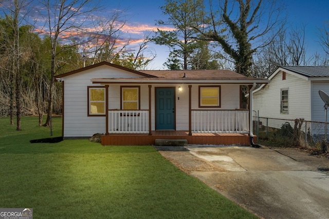 view of front facade featuring a yard and covered porch