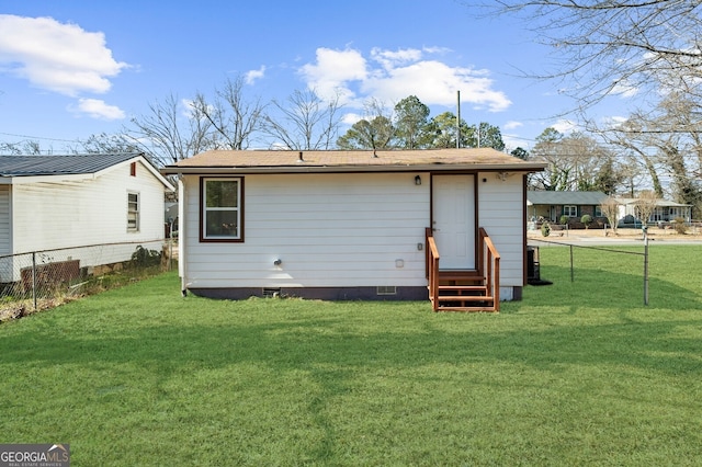 back of property featuring a lawn