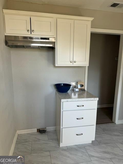 kitchen featuring white cabinetry