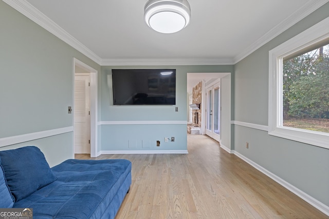 sitting room featuring crown molding and light wood-type flooring