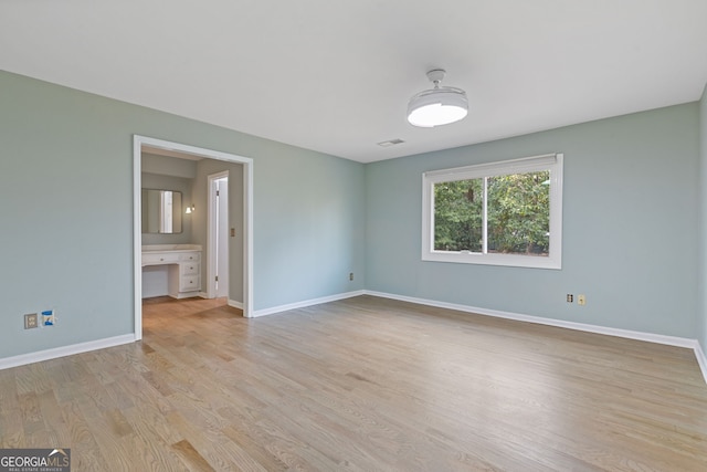 empty room with light hardwood / wood-style floors