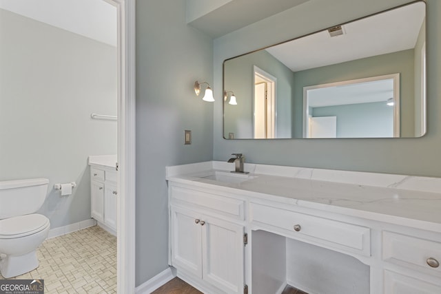 bathroom featuring vanity and toilet