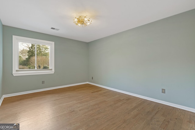 unfurnished room featuring wood-type flooring