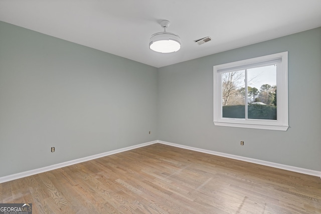 spare room featuring light wood-type flooring