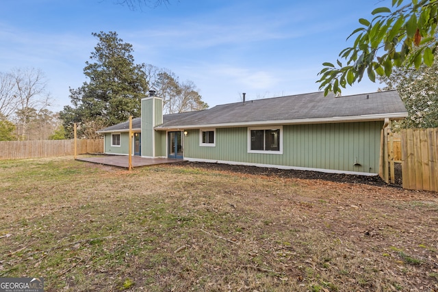 rear view of house featuring a yard and a patio area