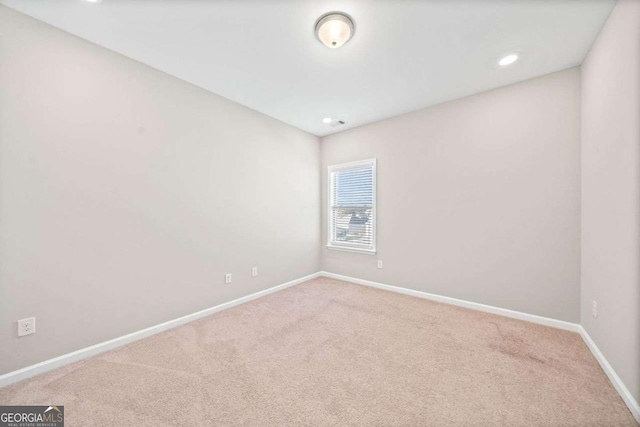 carpeted spare room featuring recessed lighting and baseboards