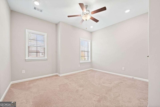 carpeted spare room featuring baseboards, visible vents, a ceiling fan, and recessed lighting