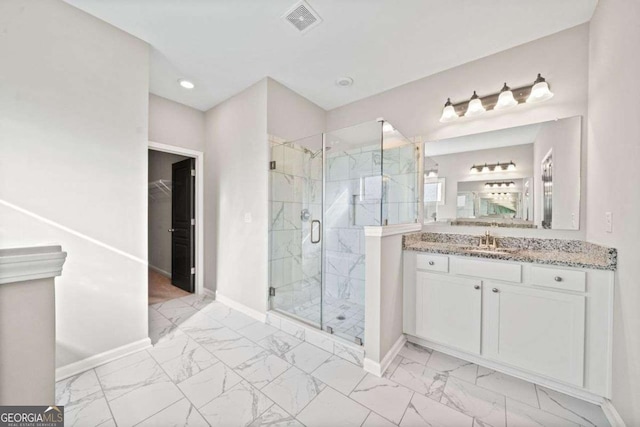 bathroom with vanity, visible vents, baseboards, marble finish floor, and a marble finish shower