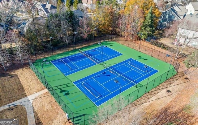 view of tennis court with fence