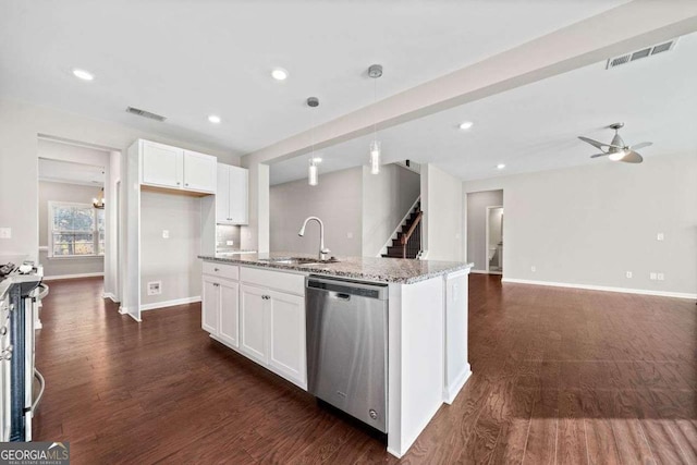 kitchen with light stone counters, a sink, visible vents, white cabinetry, and dishwasher