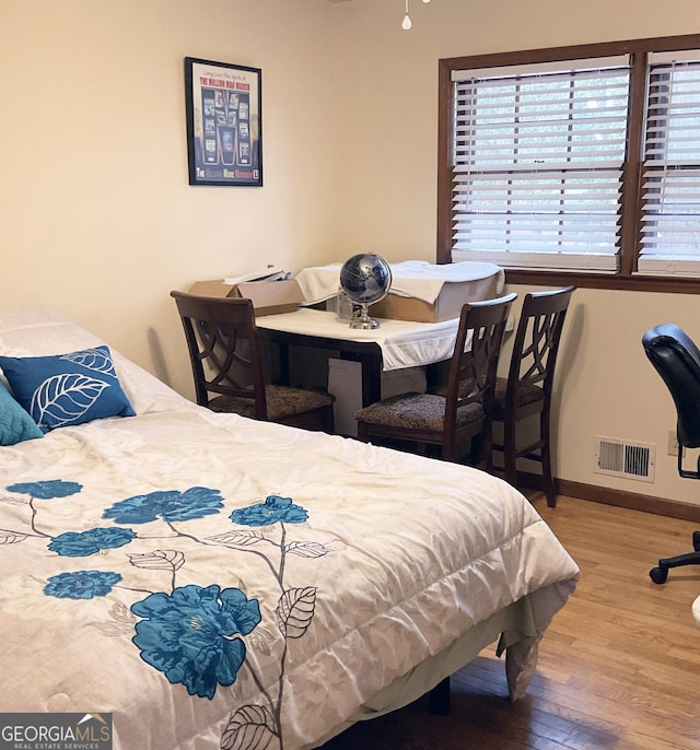 bedroom with hardwood / wood-style flooring