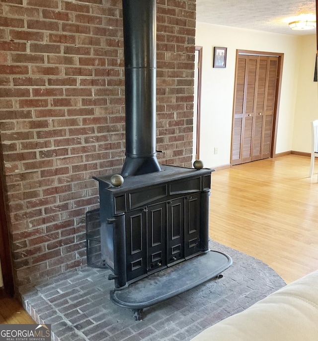 room details with wood-type flooring and a wood stove