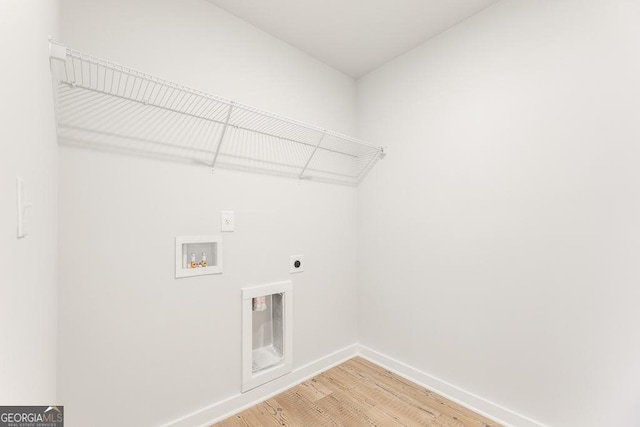 laundry area with hookup for a washing machine, hookup for an electric dryer, and hardwood / wood-style flooring