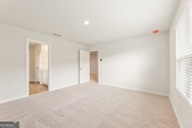 unfurnished bedroom with light colored carpet