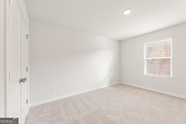 empty room with light colored carpet