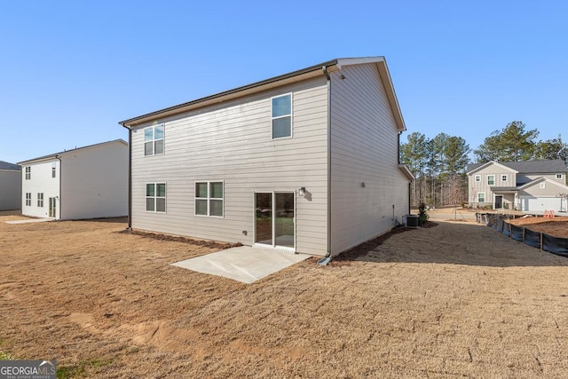 rear view of house featuring cooling unit and a patio area