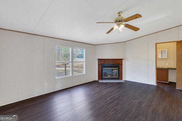 unfurnished living room with crown molding, ceiling fan, and dark hardwood / wood-style flooring