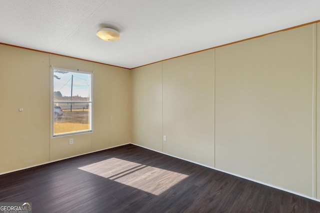 empty room with dark hardwood / wood-style flooring