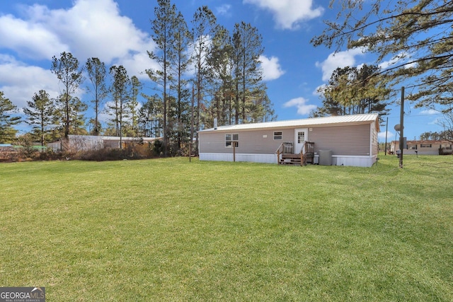 back of house with a lawn