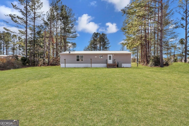 back of house featuring a yard