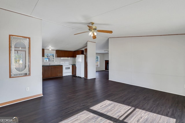 unfurnished living room with lofted ceiling, dark wood-type flooring, sink, and ceiling fan