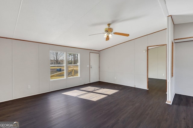 interior space with dark hardwood / wood-style flooring, ornamental molding, lofted ceiling, and ceiling fan