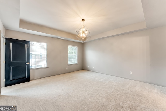 3236 Tallon Ln SW, Atlanta, GA 30311 - carpeted spare room with a tray ceiling and a chandelier