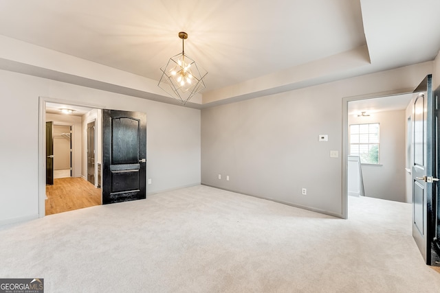 3236 Tallon Ln SW, Atlanta, GA 30311 - unfurnished room with carpet floors, a chandelier, and a tray ceiling