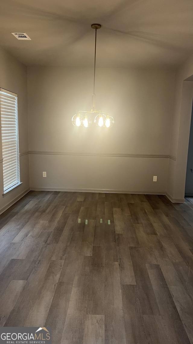 unfurnished dining area featuring dark hardwood / wood-style flooring