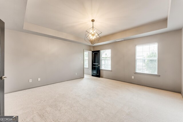 3236 Tallon Ln SW, Atlanta, GA 30311 - unfurnished room with a raised ceiling, carpet floors, and a chandelier