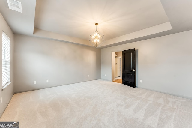 3236 Tallon Ln SW, Atlanta, GA 30311 - spare room with a chandelier, carpet, and a raised ceiling