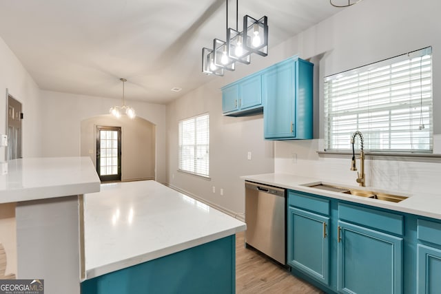 3236 Tallon Ln SW, Atlanta, GA 30311 - kitchen with dishwasher, blue cabinets, light wood-style floors, arched walkways, and decorative light fixtures
