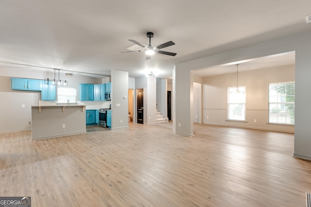 3236 Tallon Ln SW, Atlanta, GA 30311 - unfurnished living room with light wood-style flooring, ceiling fan, and a chandelier