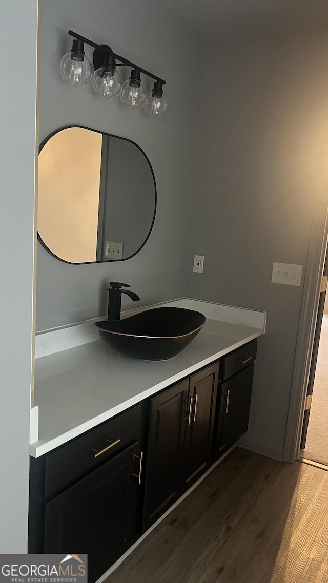 bathroom featuring hardwood / wood-style flooring and vanity