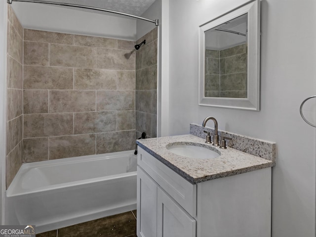 bathroom featuring vanity and tiled shower / bath