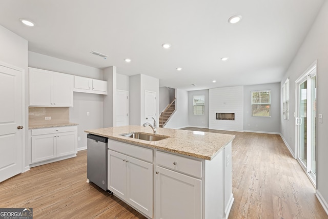 kitchen with white cabinetry, sink, and dishwasher