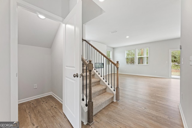 staircase featuring wood-type flooring