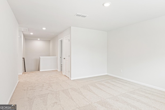 unfurnished room featuring light colored carpet