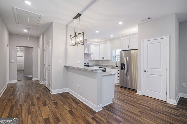 kitchen with stainless steel fridge with ice dispenser, kitchen peninsula, pendant lighting, light stone countertops, and white cabinets