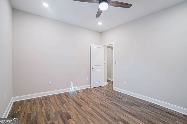 unfurnished room featuring dark wood-type flooring and ceiling fan