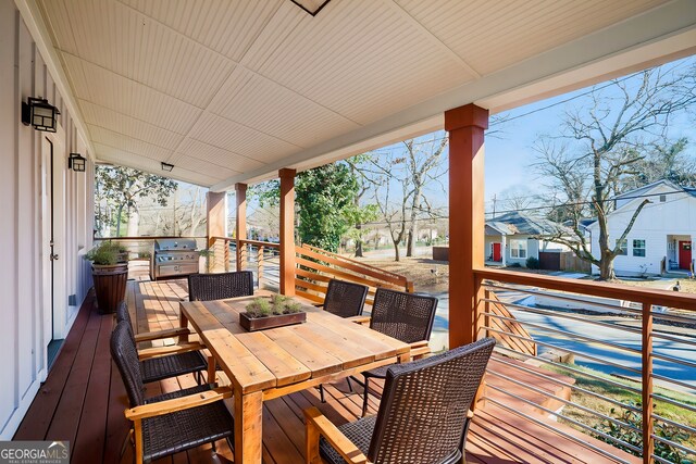 wooden terrace featuring grilling area