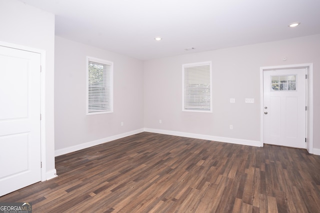 empty room with dark wood-type flooring